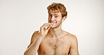 Dental care, happy and man brushing teeth in studio for fresh breath, wellness or plaque removal. Portrait, oral health and person with toothbrush for cleaning mouth with hygiene by white background.
