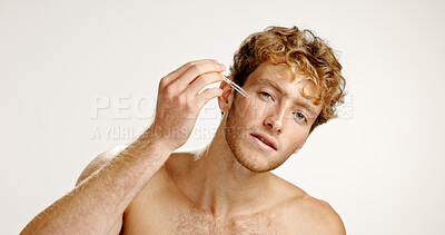 Buy stock photo Studio, man and serum for skincare, facial treatment or oil for smooth skin, cosmetics or confident. White background, portrait and person with product for hydration, beauty and moisturizer for glow