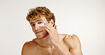 Beauty, eye patches and portrait of man in studio with natural, wellness or health routine. Skincare, collagen masks and male person with cosmetic products for dermatology by white background.