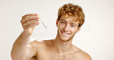 Buy stock photo Studio, man and serum for skincare, cosmetics or facial treatment for smooth skin, oil or confident. White background, happy and person with product for hydration, beauty and moisturizer for glow