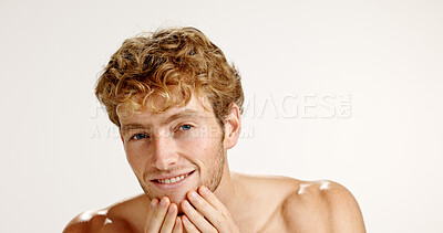 Buy stock photo Facial, portrait and smile with man in studio for grooming, hygiene or wellness routine. Beauty, lotion and skincare with person on white background to apply face cream or moisturizer in bathroom