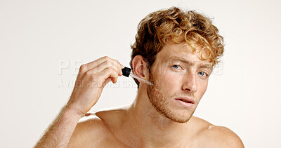 Buy stock photo Confident, man and serum for skincare, studio or facial treatment for smooth skin, oil or cosmetics. White background, portrait and person with product for hydration, beauty and moisturizer for glow