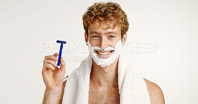 Buy stock photo Portrait, shave cream and man with razor, smile and facial product on white studio background. Face, happy person and model with towel, beard care and wellness with hair removal, beauty and grooming