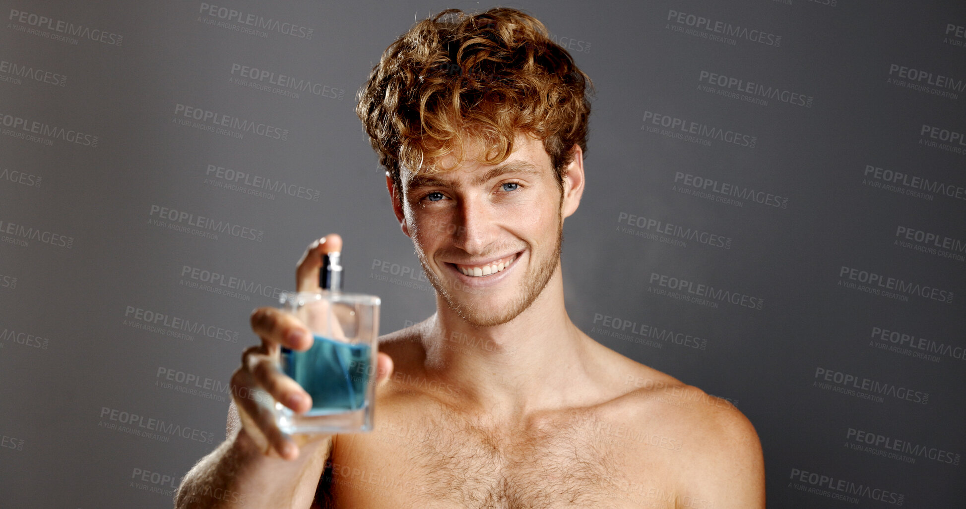 Buy stock photo Perfume, portrait and smile of man in studio with spray bottle for aroma, fragrance or fresh smell. Cologne, product and satisfaction with happy person on gray background for essence scent in glass