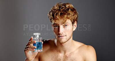 Buy stock photo Cologne, cosmetics and portrait of man in studio with spray bottle for aroma, fragrance or fresh smell. Confident, perfume and product with person on gray background for essence scent in glass