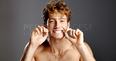Buy stock photo Dental hygiene, flossing and portrait of man in studio with fresh breath, health or plaque removal. Oral care, grooming and person with string for cleaning teeth with mouth routine on gray background
