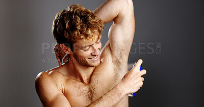 Buy stock photo Happy, man and spray for underarm, studio and product for fresh scent, grooming and morning routine. Gray background, fragrance and prevention of bad odor, smile or person with cosmetics or shirtless