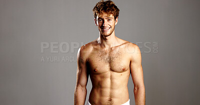 Buy stock photo Portrait, man and shirtless for skincare in studio for natural beauty, bodybuilding and abs. Smile, male person and pride for fitness progress, grooming routine and muscle growth on gray background
