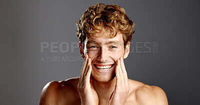 Buy stock photo Man, beauty and portrait with laugh for skincare, results and dermatology on a grey background. Red hair, self care and male model happy with cosmetics, confidence and grooming with hands on face