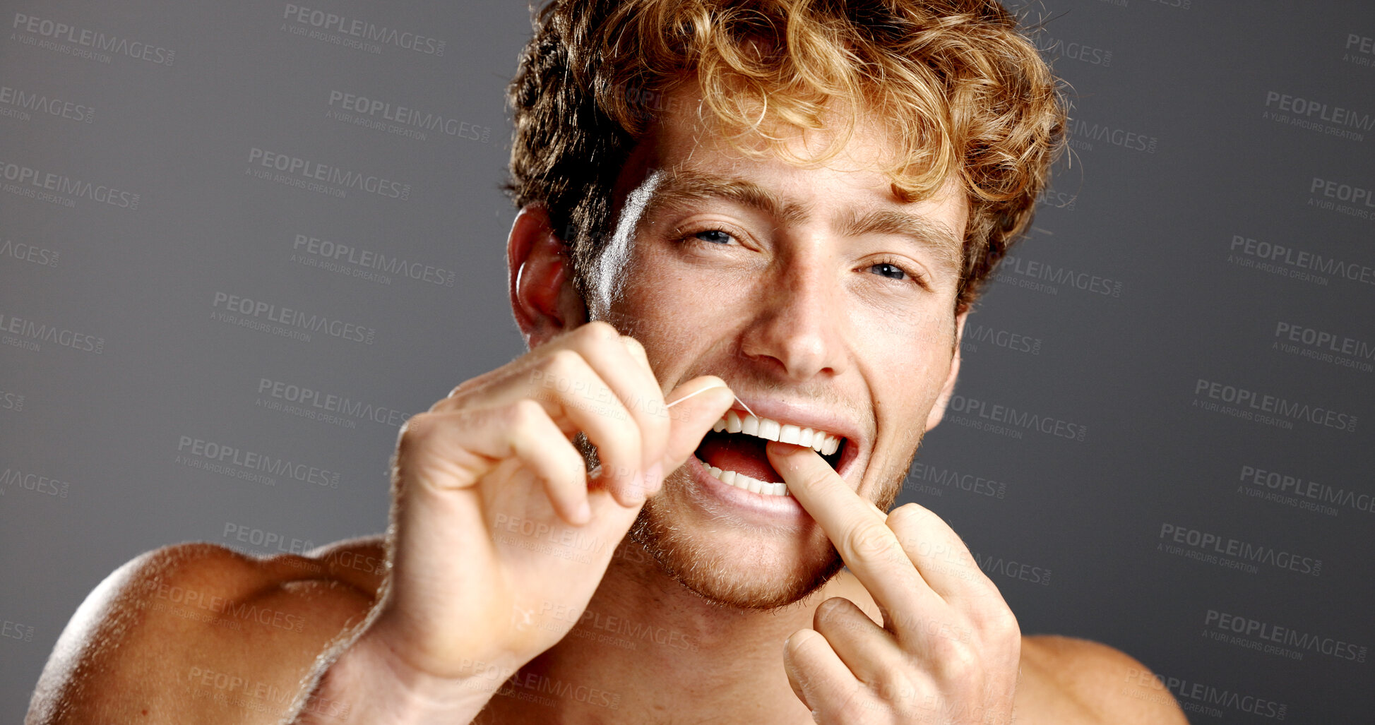 Buy stock photo Dental health, flossing and portrait of man in studio with fresh breath, grooming or plaque removal. Oral care, wellness and person with string for clean teeth with mouth routine on gray background.