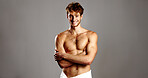 Portrait, man and arms crossed for skincare in studio of natural beauty, facial treatment and abs. Smile, male person and shirtless of dermatology glow, grooming routine and muscle on gray background