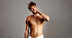 Portrait, man and topless for skincare in studio with natural beauty, facial treatment and abs. Smile, male person and confidence with dermatology glow, grooming routine and muscle on gray background