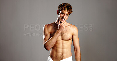 Buy stock photo Portrait, man and happy for skincare in studio of natural beauty, body transformation and results. Proud, male person and topless with towel, grooming routine and muscular growth on gray background