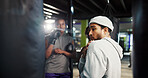 Fitness, trainer or teach defense in boxing with position, group session or training at punching bag. Man, coach or athletes in gym for instruction, combat technique or learning with sports challenge