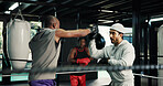 Gym, sports and training with people in boxing ring for fitness, self defense or sparring. Boxer, challenge and fight with men punching in combat for competition, exercise or performance as athlete