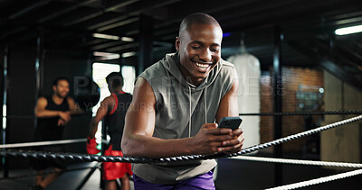 Buy stock photo Smile, athlete and man with phone in boxing ring for texting, social media and fight schedule. Male person, laugh and cellphone for chatting, streaming battle and email for progress results at gym
