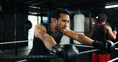 Buy stock photo Fitness, boxing ring and tired man on rope for rest, relax and health recovery for intense exercise. Athlete, boxer and break in gym with breathing, fatigue and sweat for fight challenge with sport