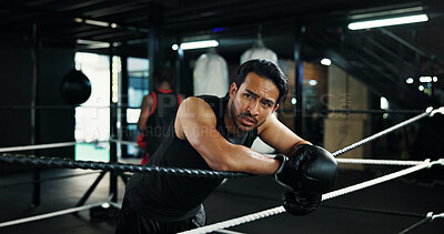 Buy stock photo Sport, boxing ring and tired man on rope for relax, rest and health recovery for intense exercise. Athlete, boxer and break in gym with breathing, fatigue and sweat for fight challenge with fitness
