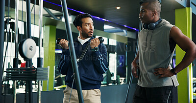 Buy stock photo Personal trainer, teaching and man with rope machine for advice, exercise and coaching. Explain, biceps and athlete in training with instructor or gym equipment, muscle and workout for fitness tips