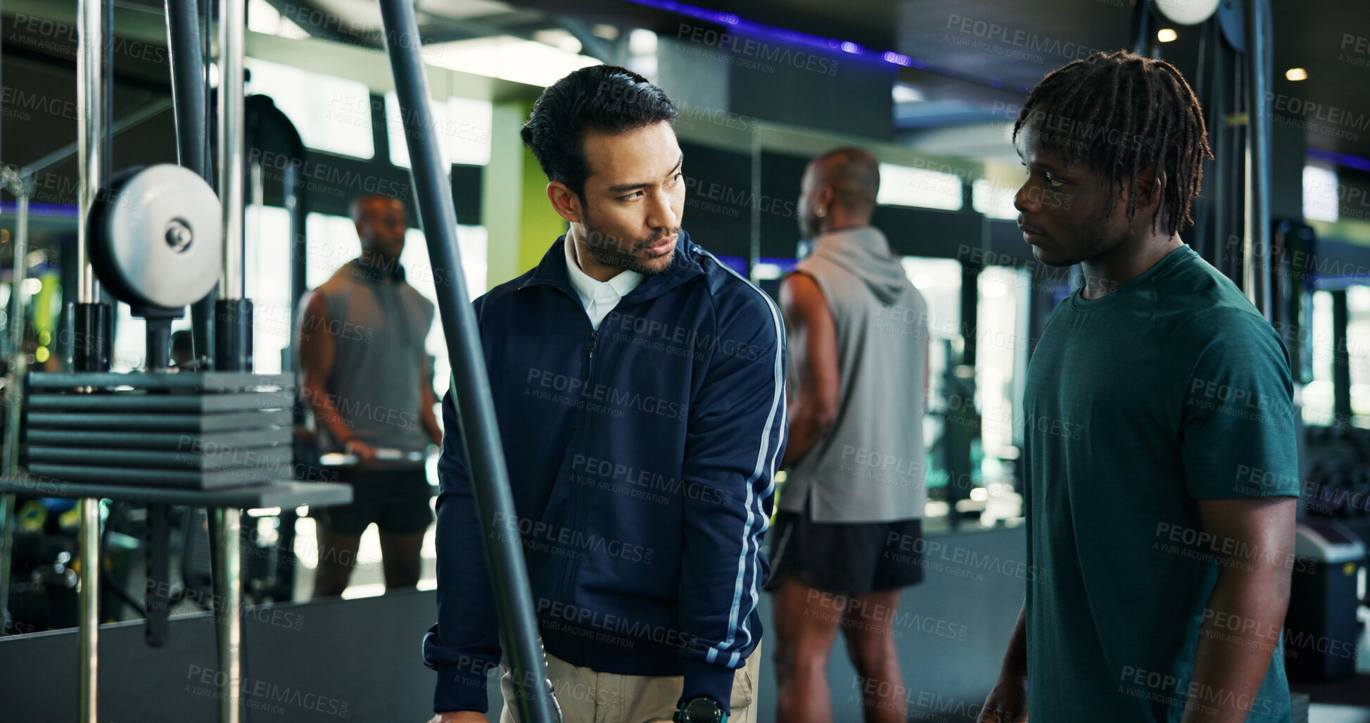 Buy stock photo Man, fitness and instructor with client in gym for instructions, tips or demonstration on machine. Male person, personal trainer or coach with member for workout, exercise or guidance in health club