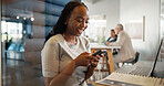 Business, woman and typing with phone in booth for finance advice, investment chat and client email. Financial advisor, hybrid work and happy black person with smartphone in office pod for research