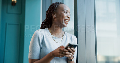 Buy stock photo Business, window and black woman with smile, cellphone and message to contact, humor or app. African person, view or employee in office, funny meme or smartphone with social media, laugh or chatting