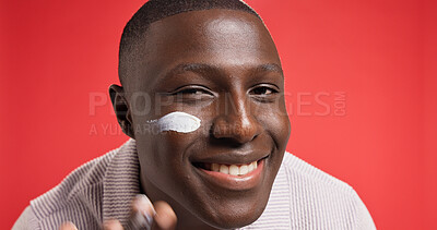 Buy stock photo Apply, smile or portrait of black man with face cream for skincare, glow or facial beauty. Space, red background or happy African male model in studio for lotion, sunscreen cosmetics or moisturiser