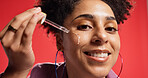 Woman, face and serum for skincare, hydration and collagen treatment with cosmetics in studio. Portrait, female person and model with pipette for facial oil, vitamin c or wellness on red background
