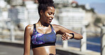 Athlete, woman and check watch in city for running speed, fitness app or track cardio performance. Sweating, african person and clock timer for monitoring workout, wellness stats or marathon training