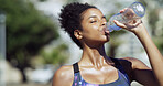 Outdoor, fitness and woman on break, drinking water and hydration with liquid, runner and digestion. Thirsty, athlete and black person with fluid for temperature regulation, healthy and wellness