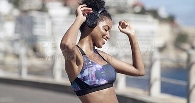 Buy stock photo Woman, dance and headphones for fitness in city for audio, listening to music and exercise podcast. Smile, African person and energy with moving, workout playlist and training with performance rhythm