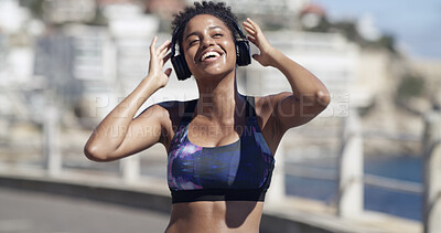 Buy stock photo Smile, woman and headphones for fitness in city for audio, listening to music and exercise podcast. African person, streaming and good mood, workout playlist and sports training of marathon practice