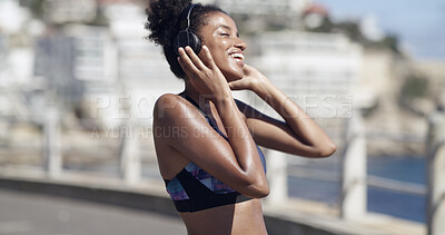 Buy stock photo Athlete, woman and headphones for fitness in city of audio, listening to music and exercise podcast. African person, streaming and good mood, workout playlist and sports training of marathon practice