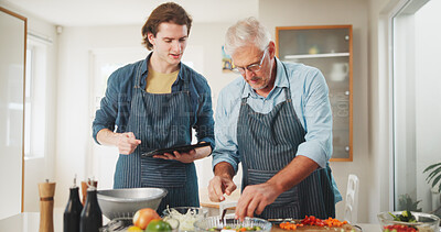Buy stock photo Men, chef or cooking with tablet in kitchen for culinary skill or hospitality in home. Mature, mentor and helping person with technology or ingredients for meal prep, house recipe or food cuisine