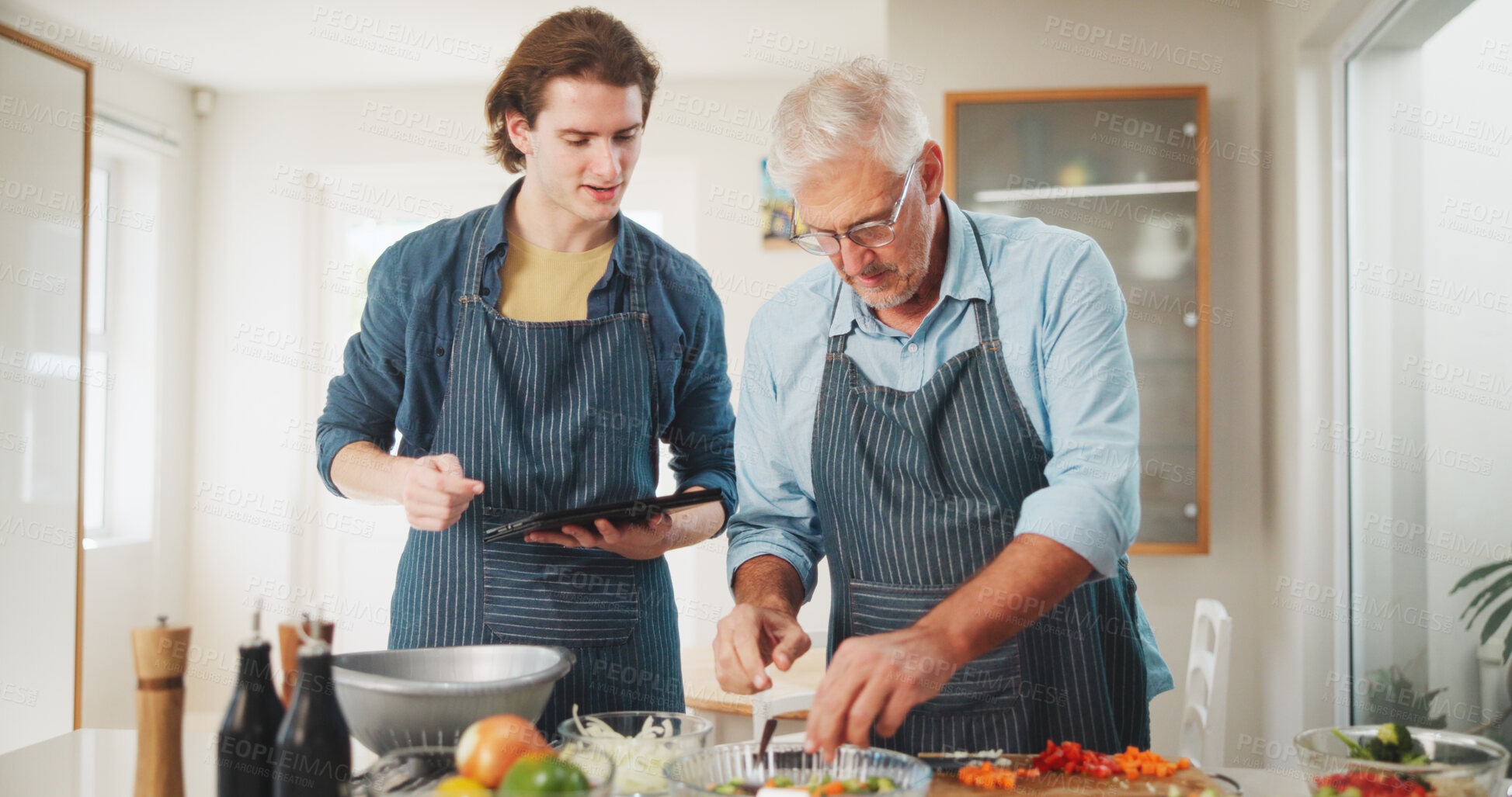 Buy stock photo Men, chef or cooking with tablet in kitchen for culinary skill or hospitality in home. Mature, mentor and helping person with technology or ingredients for meal prep, house recipe or food cuisine