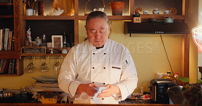 Buy stock photo Cooking, restaurant and sushi with Asian man in kitchen for culinary service or hospitality. Cleaning, recipe and seafood with mature chef preparing traditional cuisine as small business owner