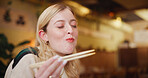 Smile, chopsticks and woman at restaurant with sushi, eating and asian cuisine for brunch, meal or choice. Diet, nutrition or traveler in Taiwan for local dining experience or immigration journey