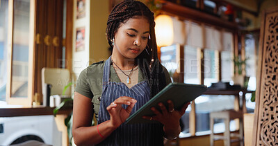 Buy stock photo Woman, barista and typing with tablet at cafe for inventory, checklist and review at restaurant. Person, tech and small business owner with notes, application and report for stock at coffee shop