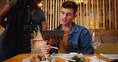Buy stock photo Man, customer and waitress with tablet at restaurant for menu, order price and reading information. People, server and digital for food choice, sushi selection and hospitality service for lunch date