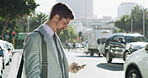 Businessman, smartphone and texting in street, travel and booking taxi on web for commute to workplace. Person, phone and profile in city with app for ride, transportation or check schedule in Spain