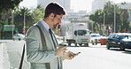 Businessman, phone and texting in city, travel and booking taxi on web for commute to workplace. Person, smartphone and scroll in town with mobile app for ride, transport or check schedule in Spain