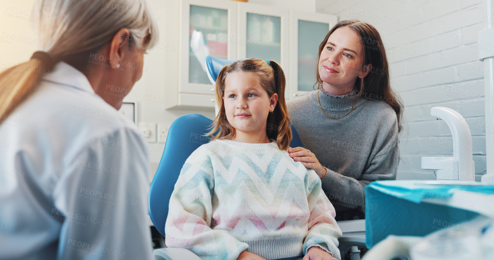 Buy stock photo Child, dentist and consultation for oral hygiene or teeth health with advice from orthodontist. Happy girl, mother or professional woman talking in clinic for dental care, wellness and checkup