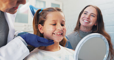 Buy stock photo Happy child, dentist and mirror for oral hygiene or teeth health with advice from orthodontist. Girl, family or woman in clinic for dental care, wellness and results or education on cleaning of mouth