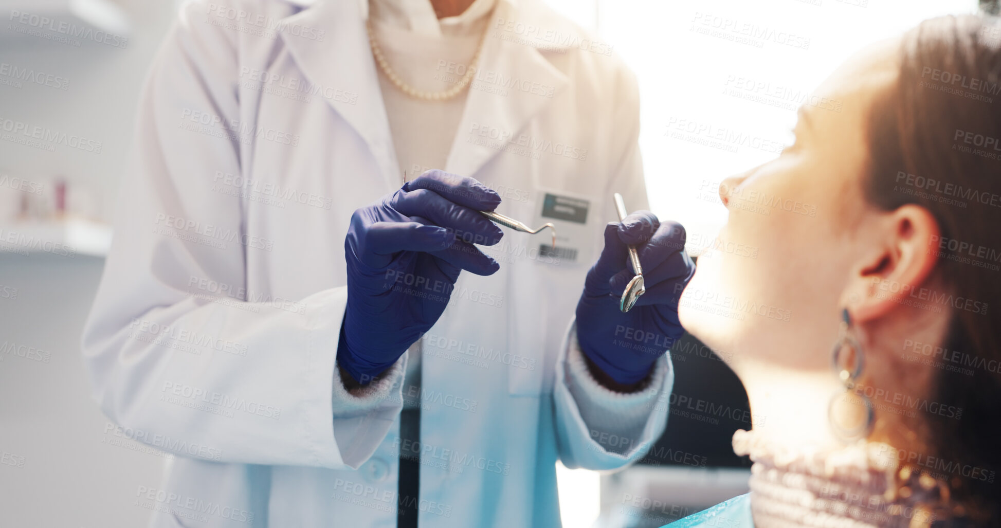 Buy stock photo Hands, patient and procedure with tools at dentist for periodontal health, gum assessment or exam. Oral hygiene, gloves and person with probe for cavity inspection, dental care and tooth extraction