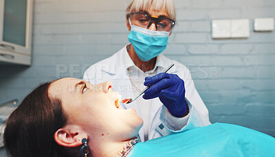 Buy stock photo Doctor, patient and procedure with mirror at dentist for mouth inspection, gum assessment or exam. Dental care, safety or women with instrument for oral cavity, tooth decay or check veneers in clinic