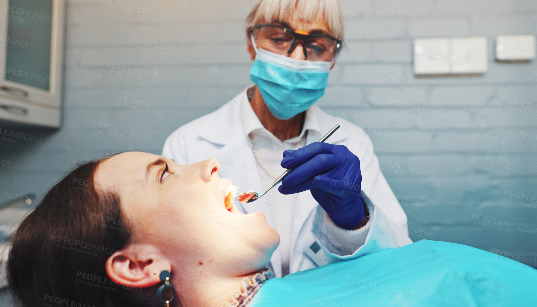 Buy stock photo Doctor, patient and procedure with mirror at dentist for mouth inspection, gum assessment or exam. Dental care, safety or women with instrument for oral cavity, tooth decay or check veneers in clinic