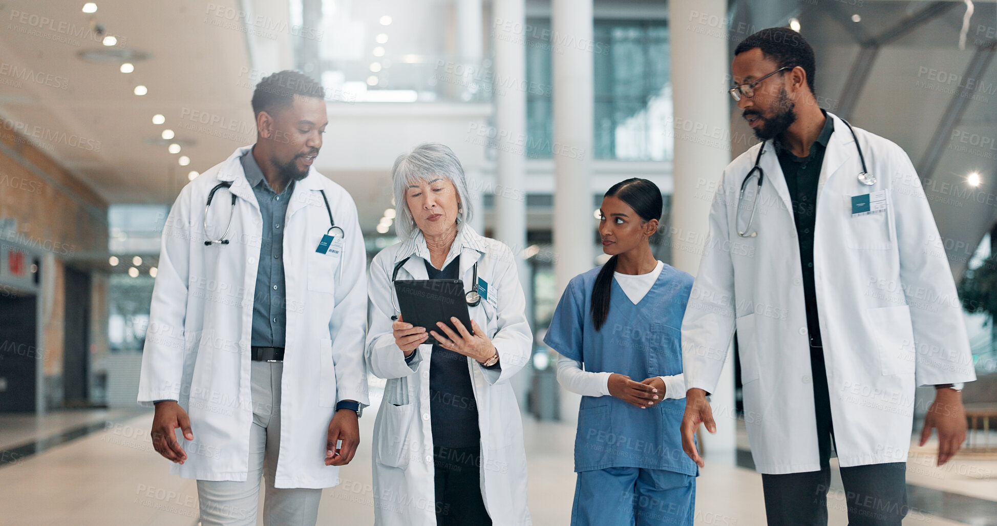 Buy stock photo Doctor, woman and tablet with team in lobby with discussion, review and medical research at clinic. People, mature leader and group with tech, feedback and report with healthcare services at hospital