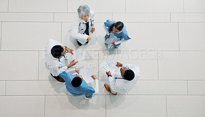 Buy stock photo Doctor, medical team and meeting with documents for healthcare development or mission above. Top view, group or health employees with paperwork in huddle for progress or performance at hospital