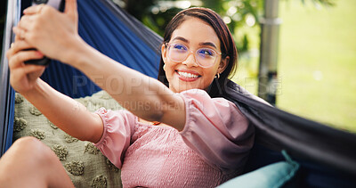 Buy stock photo Outdoor, tourist and woman on hammock, selfie and photography for summer vacation, happy and travel. Relax, traveller and person with smile for profile picture, post and memory for holiday or trip