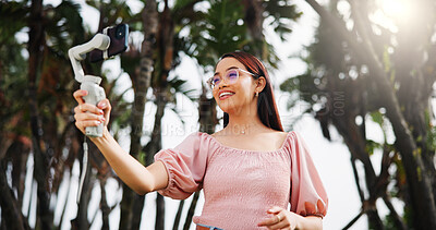 Buy stock photo Phone gimbal, live streaming and woman outdoor for travel, vlog and tourism review. Mobile, smile and influencer at park for recording video, social media and broadcast on holiday with low angle